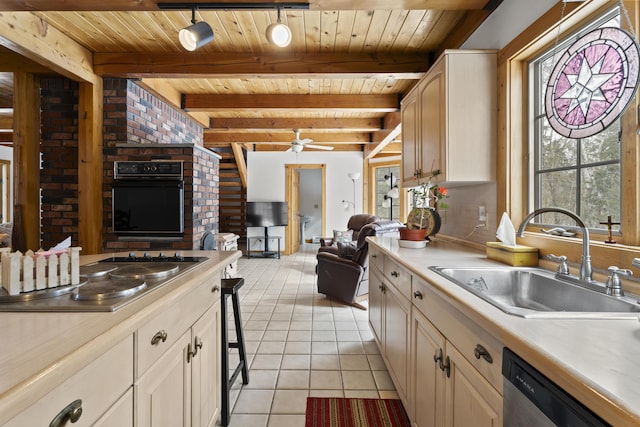 kitchen with beamed ceiling, a sink, stainless steel appliances, light tile patterned flooring, and ceiling fan