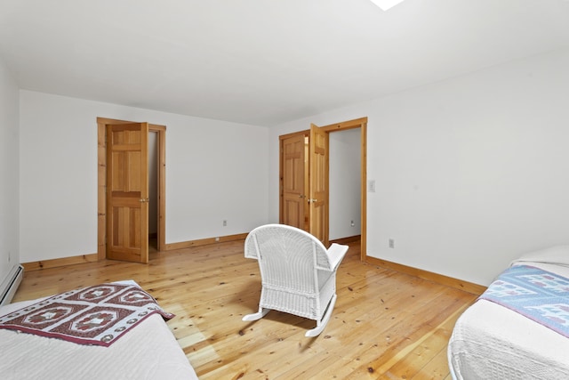 bedroom featuring light wood-type flooring and baseboards