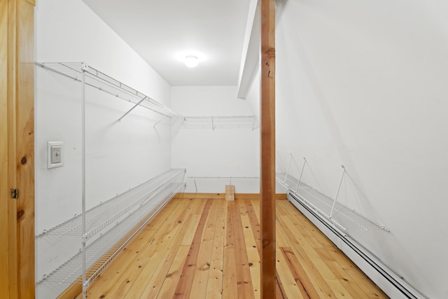 walk in closet featuring a baseboard radiator and wood-type flooring