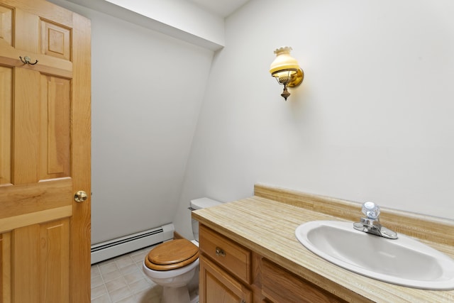 half bathroom featuring tile patterned floors, vanity, toilet, and a baseboard heating unit
