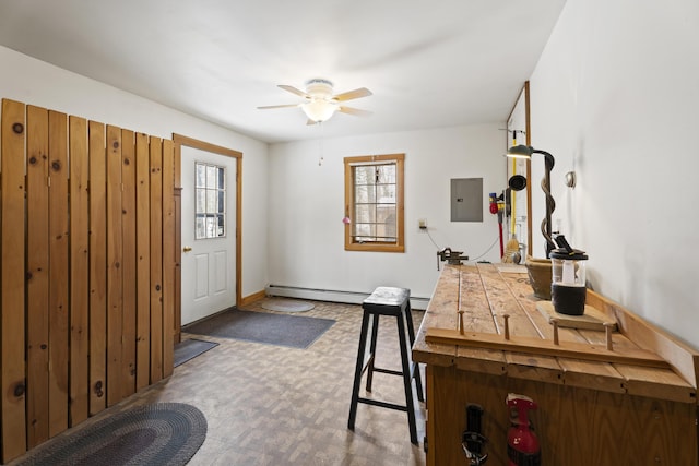 foyer entrance featuring electric panel, a baseboard heating unit, and a ceiling fan