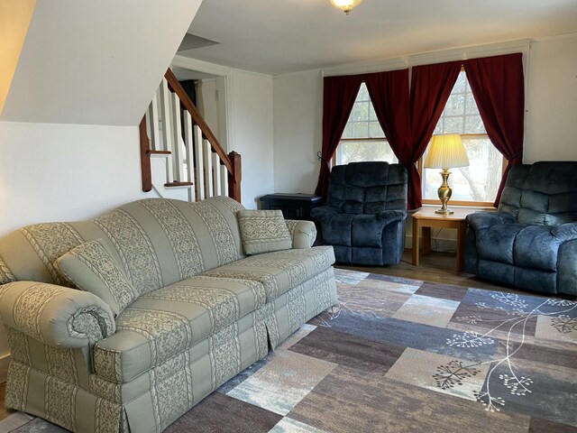 living room with stairs and wood finished floors