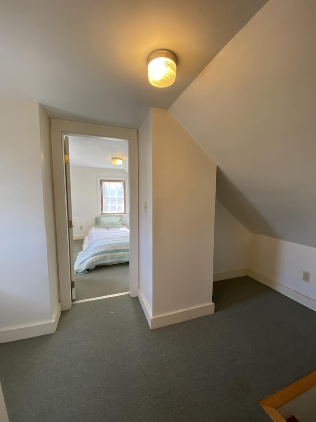 bonus room with lofted ceiling, baseboards, and carpet floors