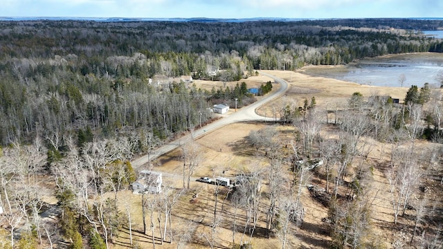 aerial view with a water view and a forest view