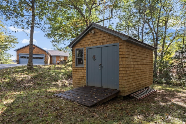 view of outbuilding featuring an outbuilding and a garage
