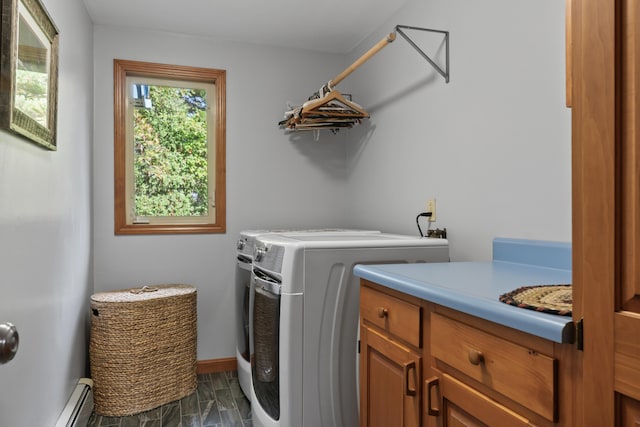 clothes washing area featuring cabinet space, washing machine and dryer, baseboard heating, and baseboards