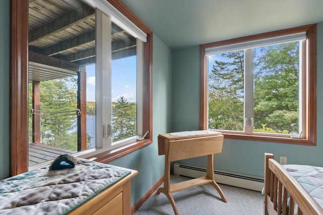 carpeted bedroom featuring baseboard heating and baseboards