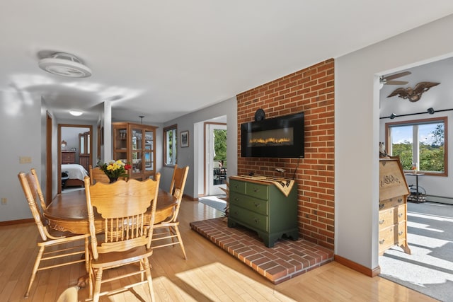 dining area featuring light wood-type flooring and baseboards