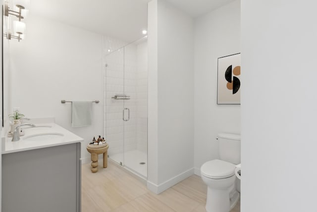 full bath featuring a sink, baseboards, toilet, and a shower stall