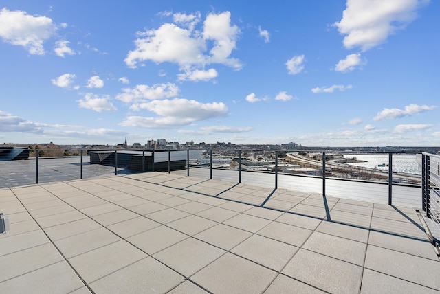 view of patio with a city view and a water view