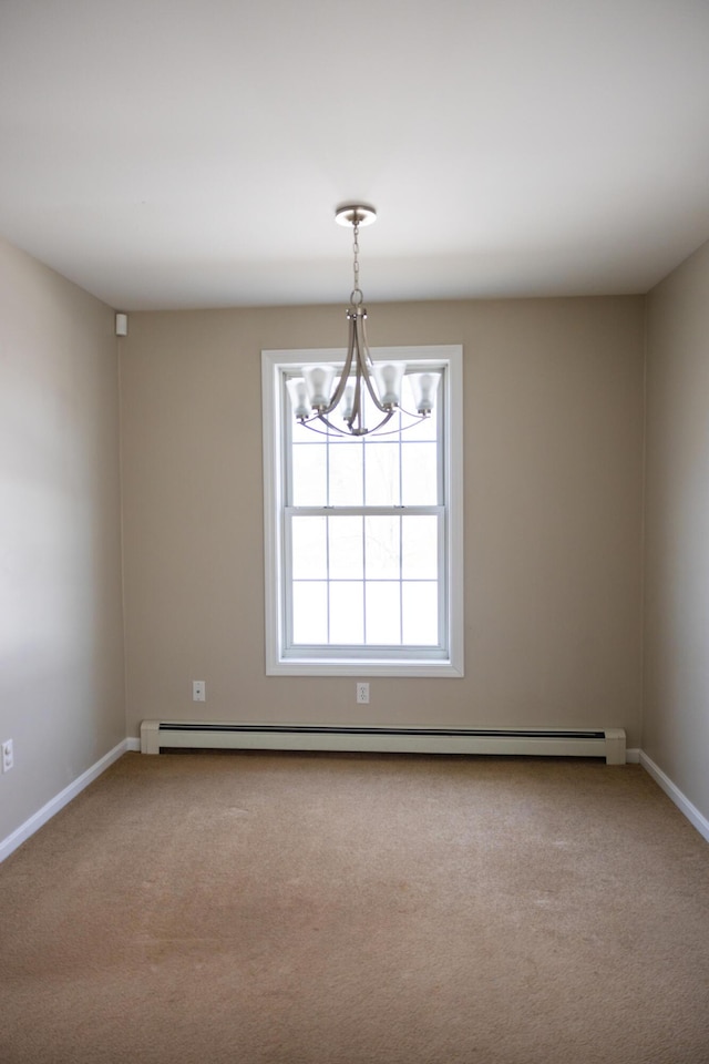 carpeted spare room with baseboard heating, baseboards, and an inviting chandelier