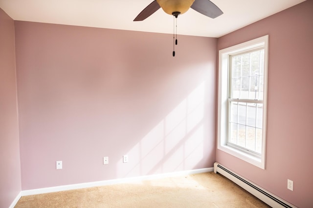 spare room with a baseboard radiator, baseboards, and carpet