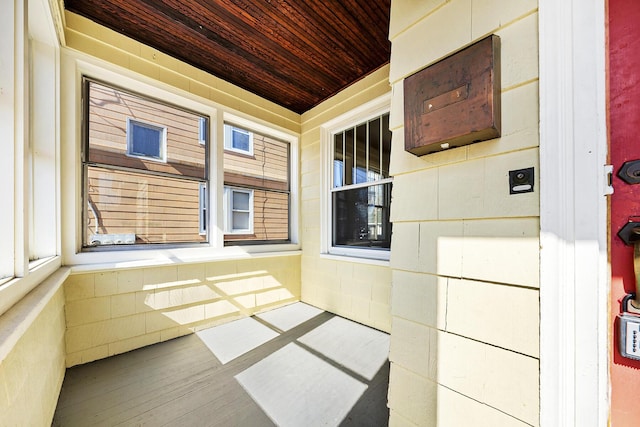 unfurnished sunroom featuring wood ceiling