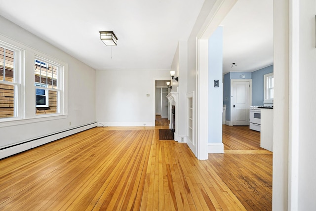 unfurnished living room featuring light wood-type flooring, baseboards, and baseboard heating