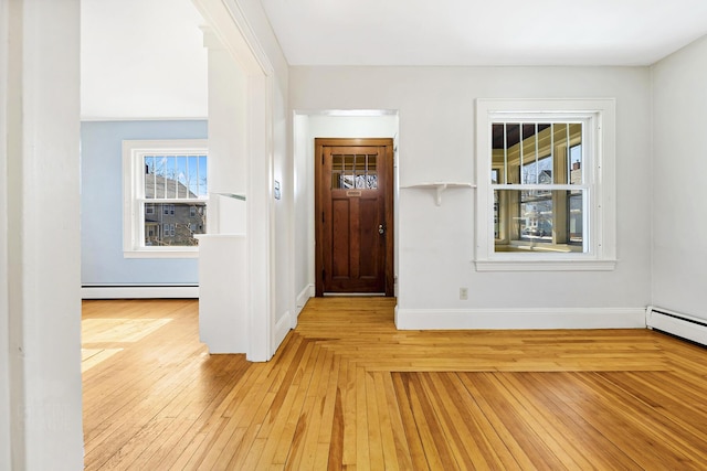 entryway with a baseboard radiator, baseboards, and hardwood / wood-style floors