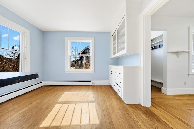 interior space with light wood-style floors, baseboards, and baseboard heating