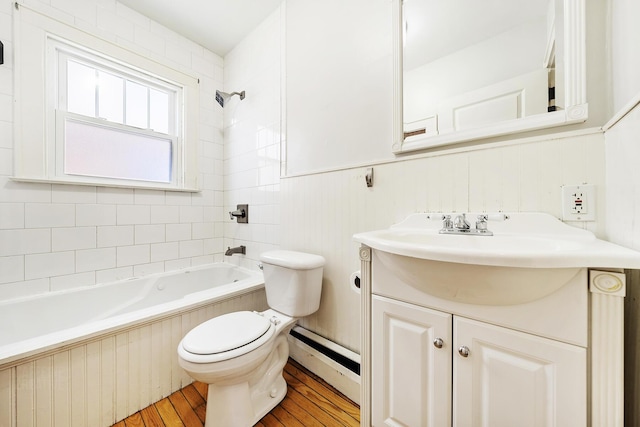 full bathroom with a wainscoted wall, toilet, shower / bathing tub combination, wood finished floors, and vanity