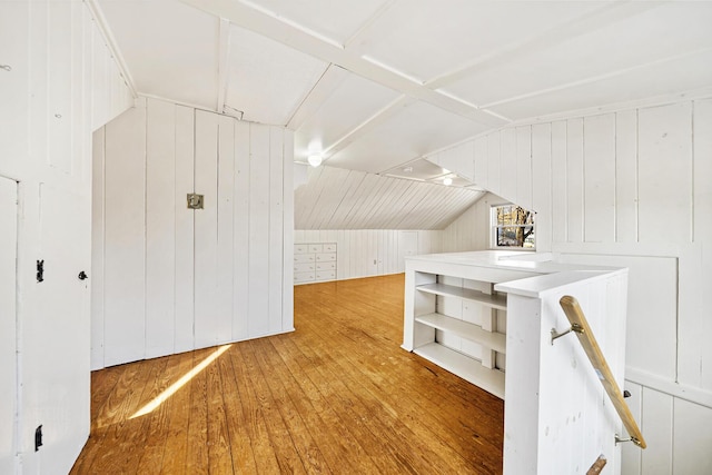 additional living space with vaulted ceiling and hardwood / wood-style floors