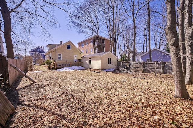 view of yard with an outdoor structure and a fenced backyard