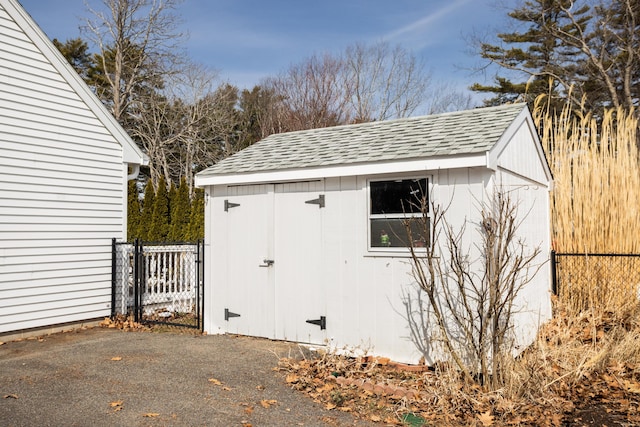 view of shed featuring fence