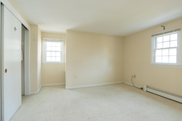 carpeted spare room with baseboards and baseboard heating