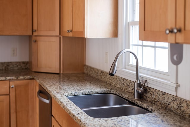 kitchen featuring dishwasher and a sink