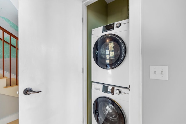 washroom featuring laundry area and stacked washer and dryer