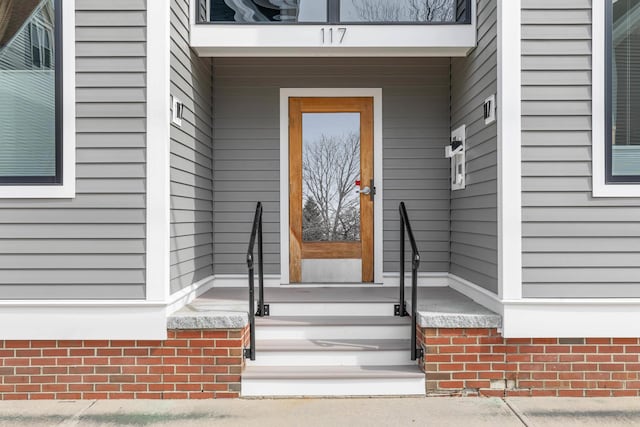 property entrance with brick siding