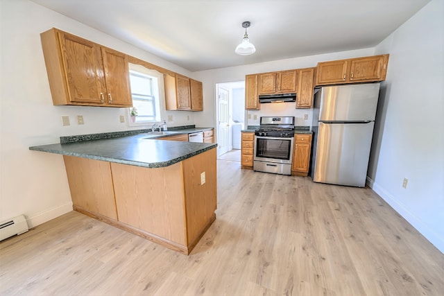 18 Oak St, Camden, ME 04843 - kitchen featuring stainless steel appliances, under cabinet range hood, dark countertops, and light wood-style floors