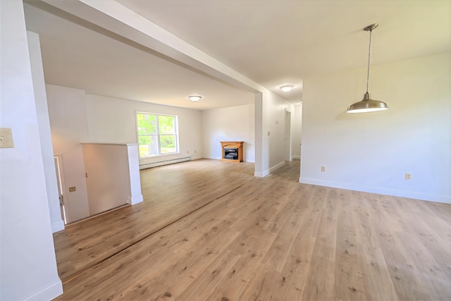 18 Oak St, Camden, ME 04843 - unfurnished living room featuring light wood finished floors, a baseboard heating unit, and a fireplace