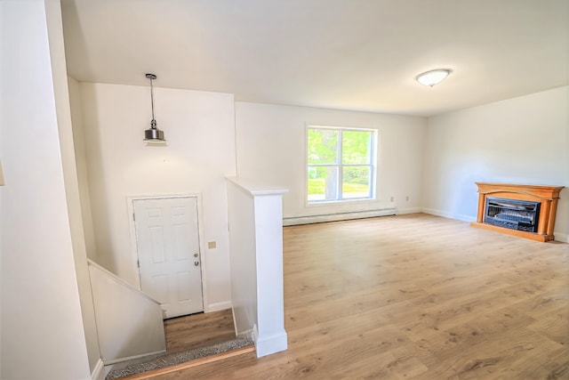 18 Oak St, Camden, ME 04843 - entryway with a baseboard heating unit, wood finished floors, and a fireplace