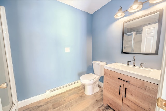 18 Oak St, Camden, ME 04843 - full bath featuring a baseboard heating unit, a shower stall, wood finished floors, and vanity