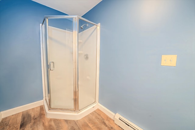18 Oak St, Camden, ME 04843 - full bathroom with wood finished floors, a stall shower, and a baseboard radiator