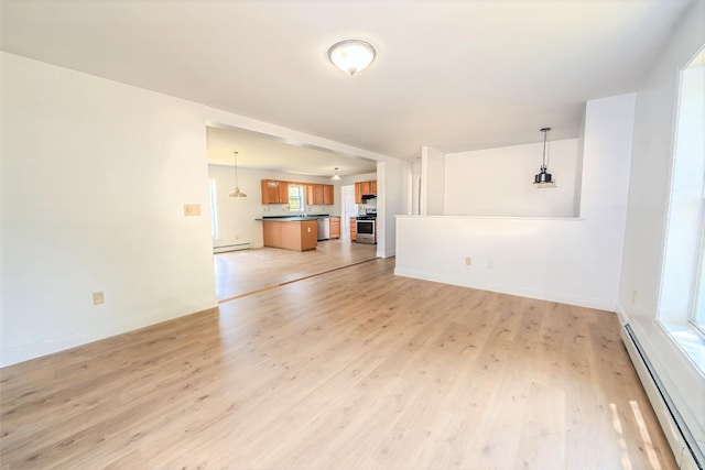 18 Oak St, Camden, ME 04843 - unfurnished living room featuring a baseboard heating unit and light wood-style flooring