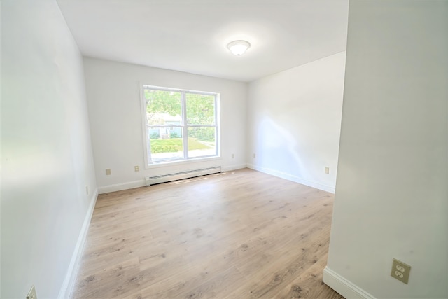 18 Oak St, Camden, ME 04843 - empty room featuring a baseboard heating unit and light wood finished floors