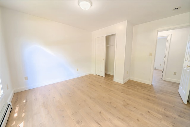 18 Oak St, Camden, ME 04843 - unfurnished bedroom with a baseboard radiator, light wood-style floors, and a closet
