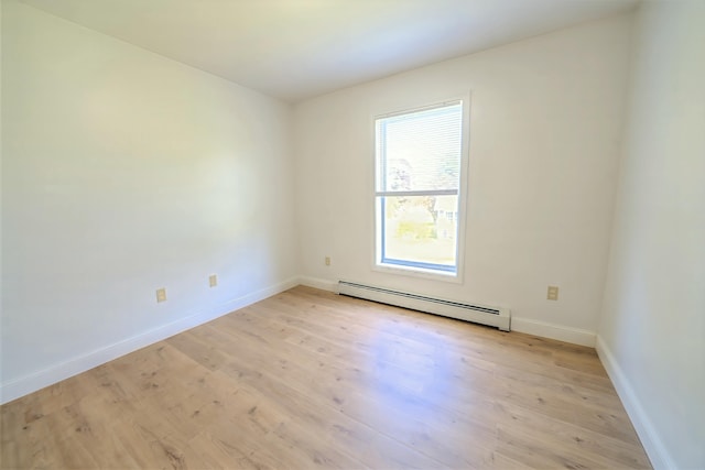 18 Oak St, Camden, ME 04843 - empty room with a baseboard heating unit and light wood-style floors