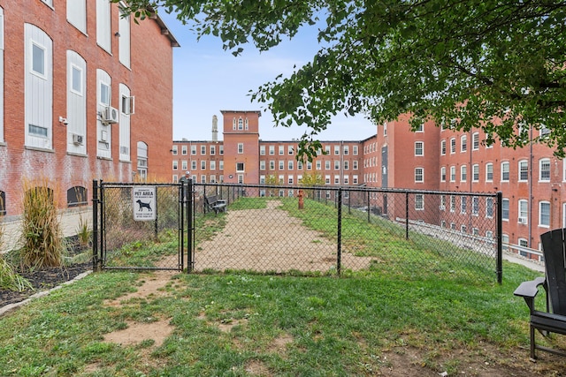 surrounding community with a gate, a lawn, and fence