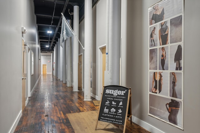 hall with baseboards and hardwood / wood-style flooring