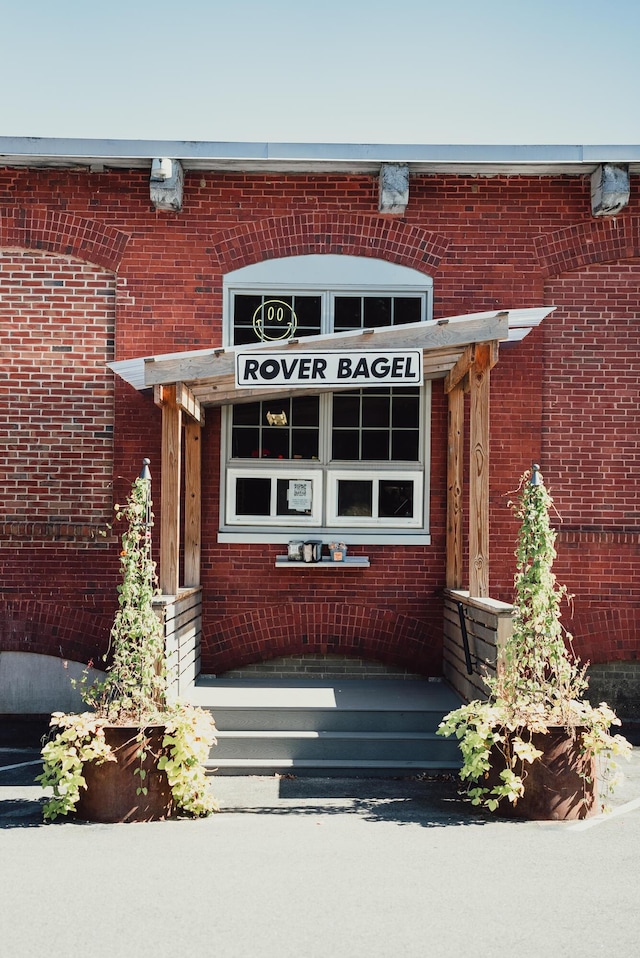 property entrance with brick siding