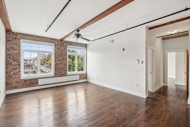 empty room with radiator, brick wall, ceiling fan, and hardwood / wood-style floors