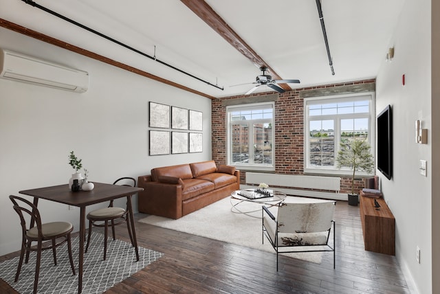 living area with hardwood / wood-style floors, a wall unit AC, radiator heating unit, and brick wall