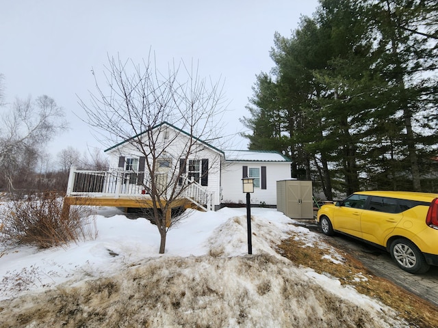 view of front of home featuring an outdoor structure and a wooden deck