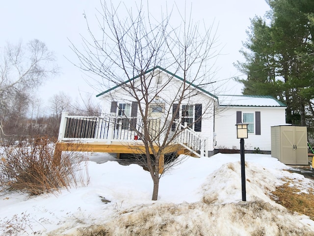 exterior space with a storage unit, an outbuilding, and a wooden deck