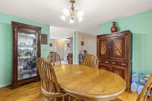 16 Rockaway Rd, Falmouth, ME 04105 - dining space with light wood-style flooring, a notable chandelier, and baseboards