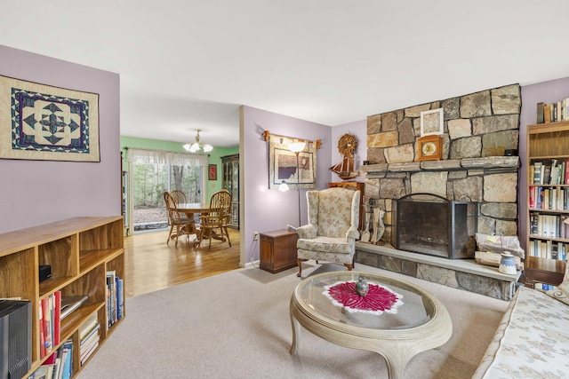 16 Rockaway Rd, Falmouth, ME 04105 - living room with a fireplace, a notable chandelier, and carpet floors