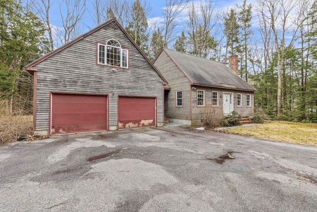 16 Rockaway Rd, Falmouth, ME 04105 - view of front of house featuring aphalt driveway and a chimney