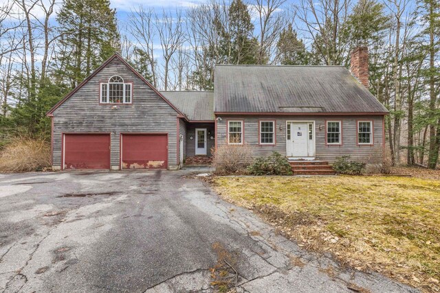 16 Rockaway Rd, Falmouth, ME 04105 - view of front of home featuring a chimney, driveway, a garage, and a front lawn
