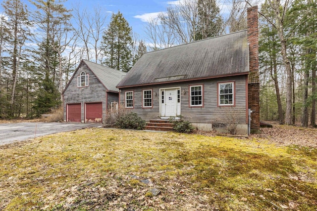 16 Rockaway Rd, Falmouth, ME 04105 - view of front of home featuring aphalt driveway, an attached garage, a chimney, and a front lawn