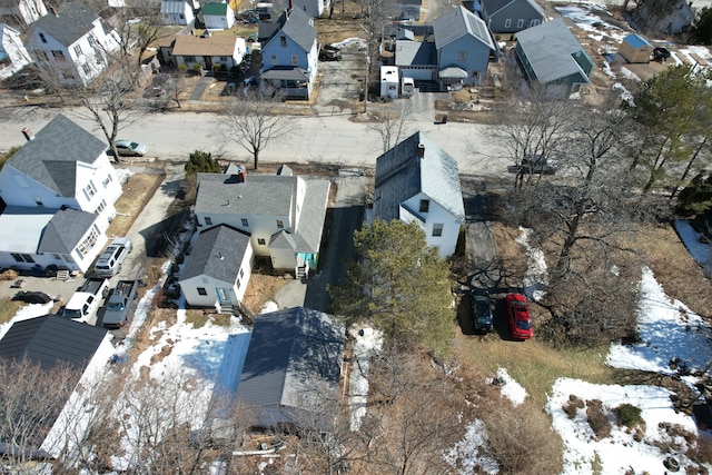 snowy aerial view with a residential view